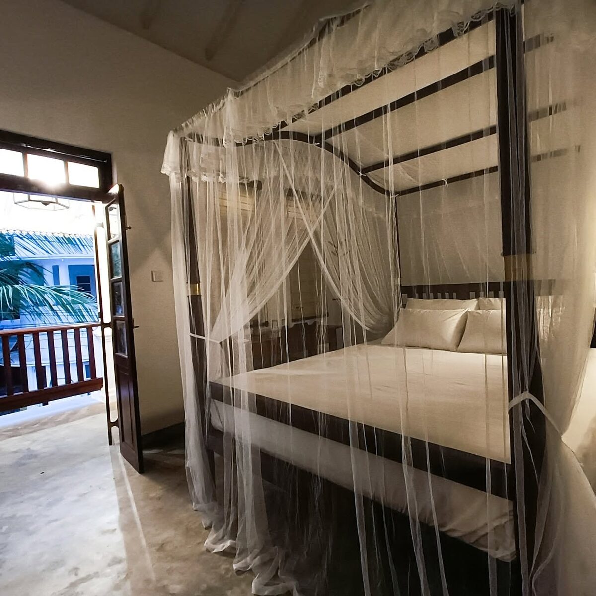Four-poster canopy bed with netting